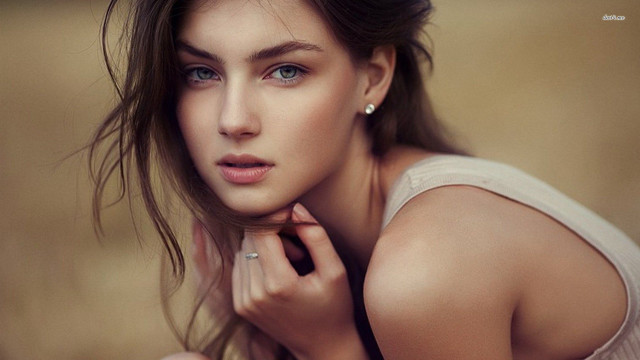 Woman ring pose brown background free wallpaper for desktop - medium preview image