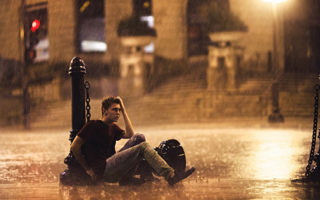 Man sitting ground rain hands free wallpaper for desktop - medium preview image