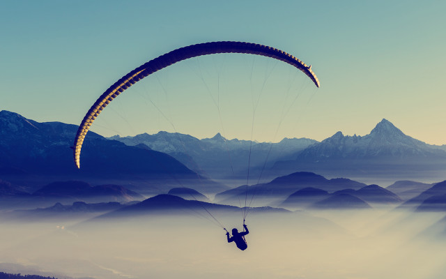 Parasailing mountains foggy sky ocean free wallpaper for desktop - medium preview image