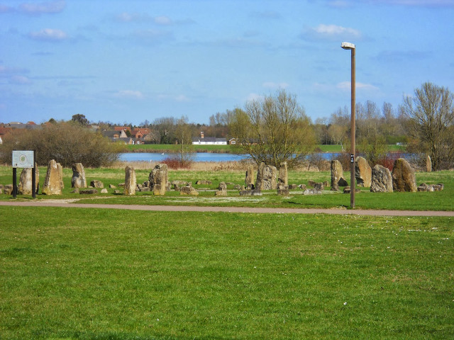 Grassy field large rocks sign free wallpaper for desktop - medium preview image