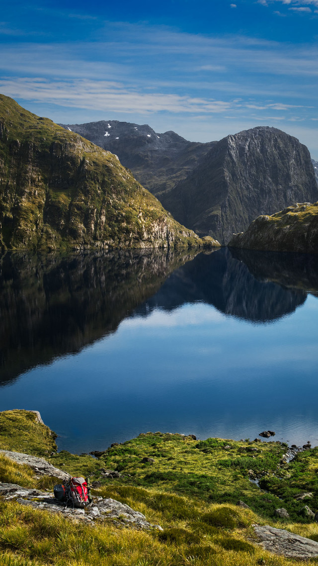 Lake mountains grass person sitting free wallpaper for mobile - medium preview image