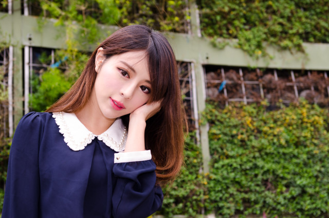 Woman blue shirt green wall free wallpaper for desktop - medium preview image