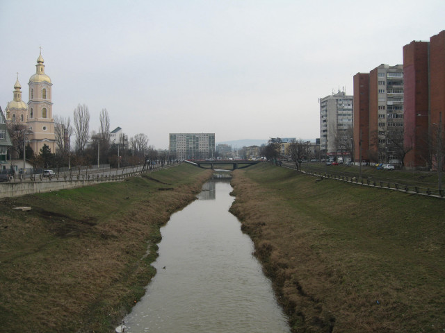 River lush field tall buildings free wallpaper for desktop - medium preview image