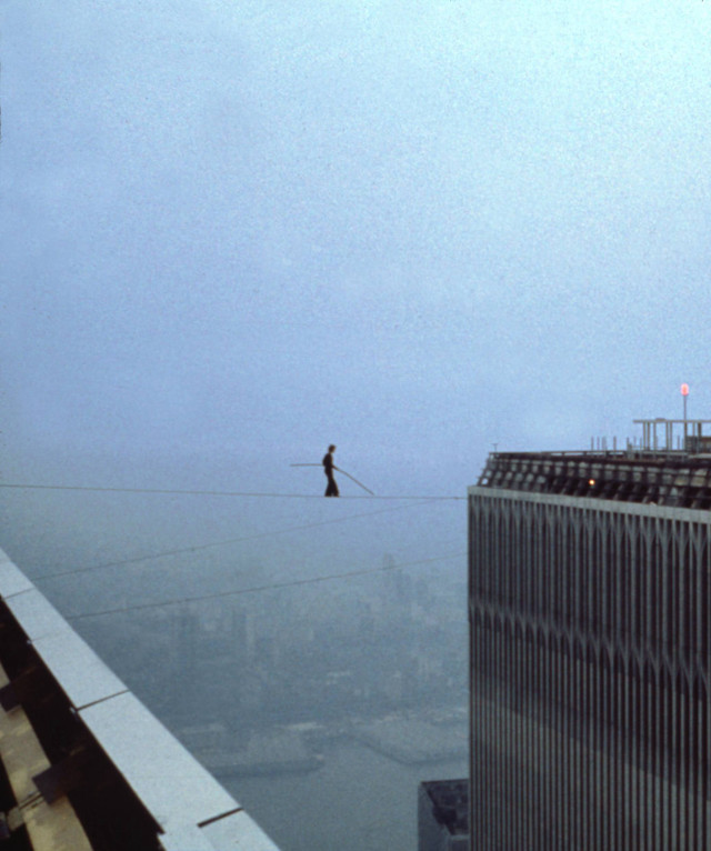 Man tightrope walking city skyline free wallpaper for mobile - medium preview image