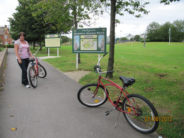 Woman red bike sidewalk sign free wallpaper for desktop - medium preview image