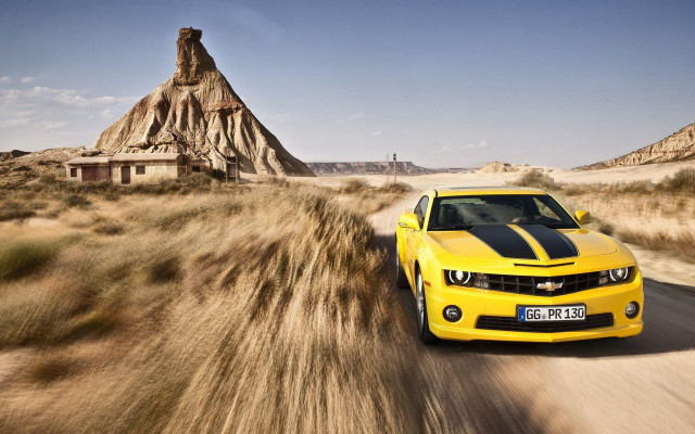 Yellow car dirt road desert free wallpaper for desktop - medium preview image