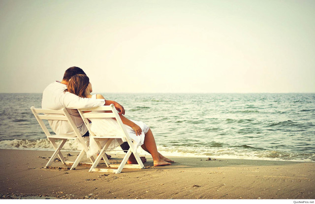 Couple sitting beach ocean looking free wallpaper for desktop - medium preview image