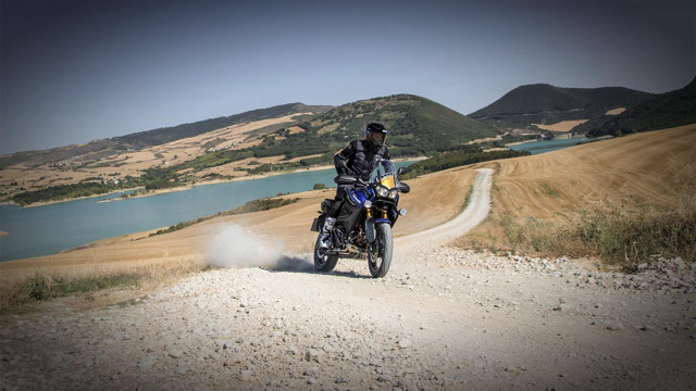 Man motorcycle dirtroad lake mountains free wallpaper for desktop - medium preview image