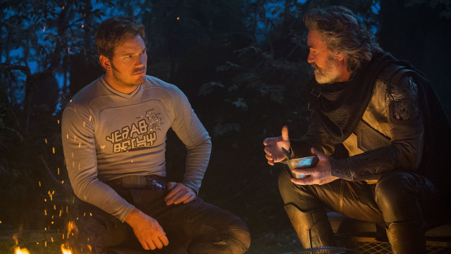 Campfire men drinks cellphone sitting free wallpaper for desktop - medium preview image