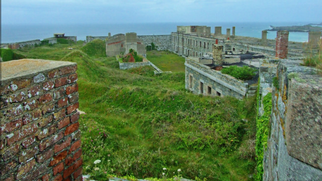 Grassy area building ocean clouds free wallpaper for desktop - medium preview image