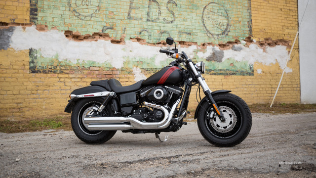 Motorcycle parked brick wall graffiti free wallpaper for desktop - medium preview image