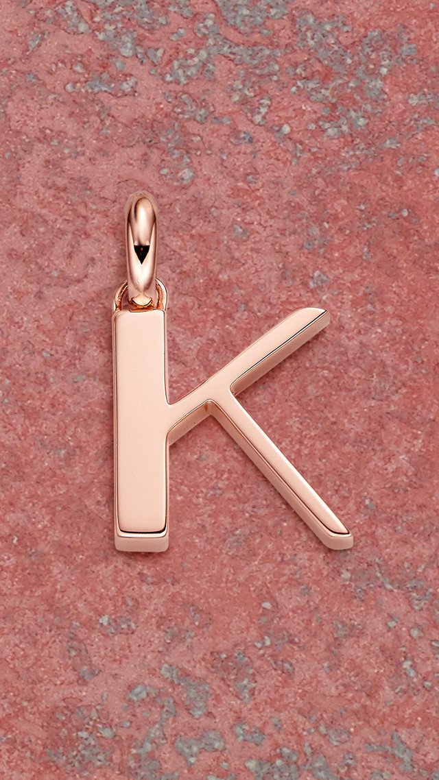 Gold letter k pink surface free wallpaper for mobile - medium preview image