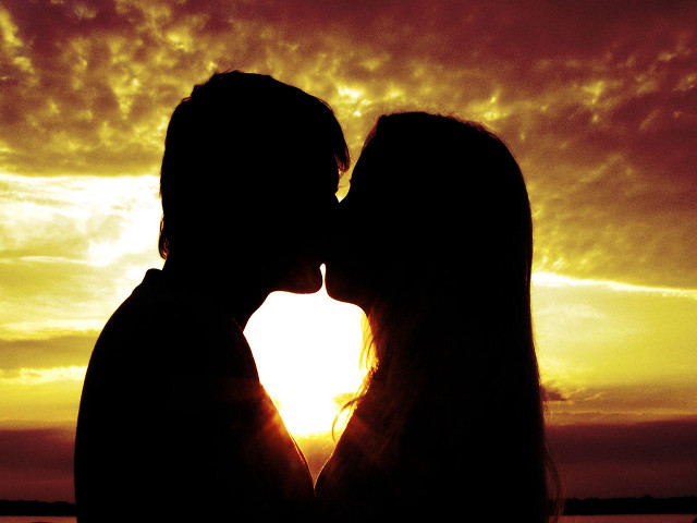 Couple kissing sunset sky clouds free wallpaper for desktop - medium preview image