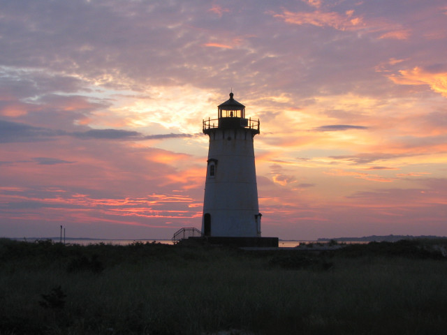 Lighthouse sunset silhouette clouds grassy free wallpaper for desktop - medium preview image