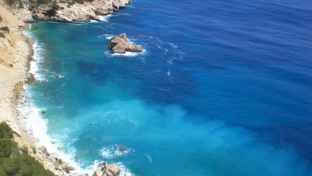 Beach cliff blue water rock free wallpaper for desktop - medium preview image
