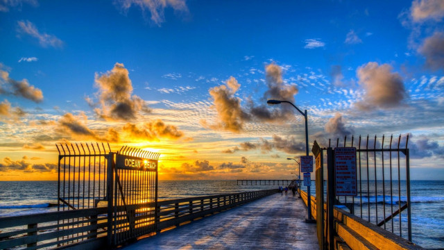 Pier fence sunset ocean cityscape free wallpaper for desktop - medium preview image