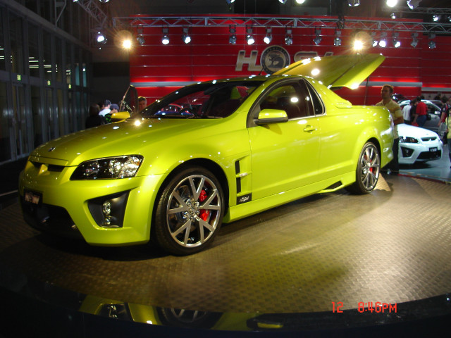 Yellow car showroom display people free wallpaper for desktop - medium preview image