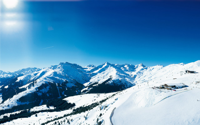 Skiing snowy mountain sun blue free wallpaper for desktop - medium preview image