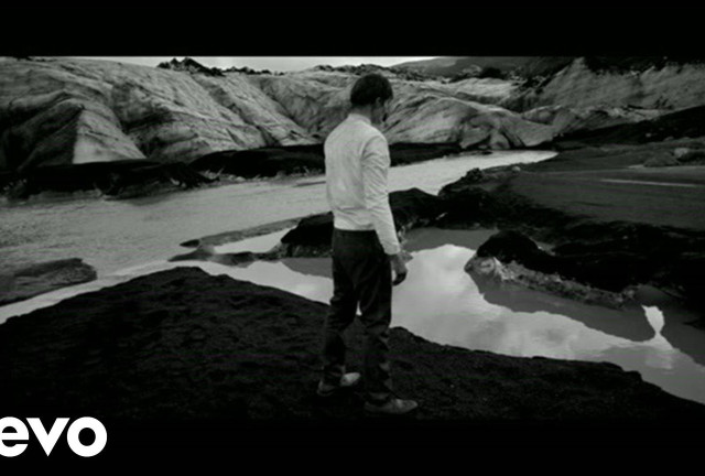 Man standing rocky hillside river free wallpaper for desktop - medium preview image