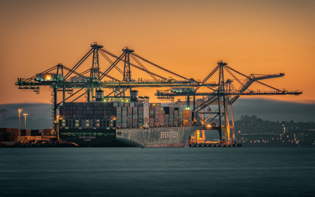 Cargo ship sunset cityscape bridge free wallpaper for desktop - medium preview image