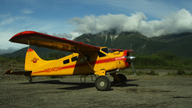 Small yellow airplane mountains clouds free wallpaper for desktop - medium preview image