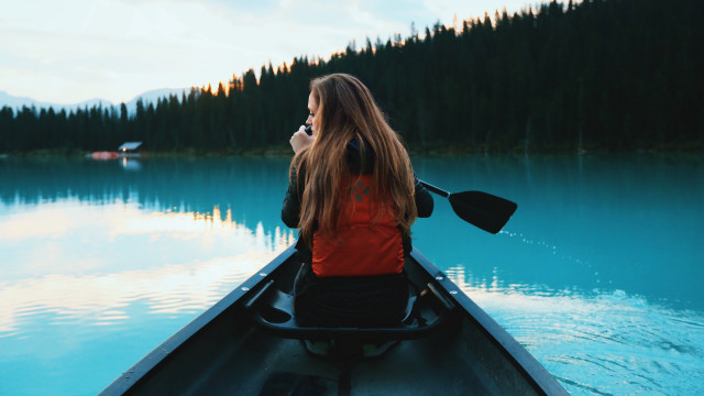 Woman red jacket canoe lake free wallpaper for desktop - medium preview image