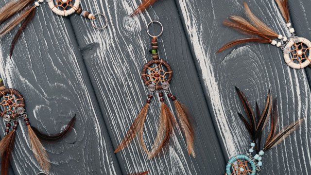 Feathers beads wooden surface keychain free wallpaper for desktop - medium preview image