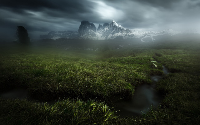Grassy field stream cloudy mountains free wallpaper for desktop - medium preview image