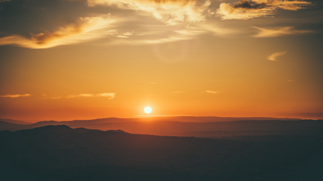 Sunset clouds hills ocean reflection free wallpaper for desktop - medium preview image