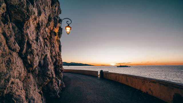 Cliff side streetlight ocean sunset free wallpaper for desktop - medium preview image