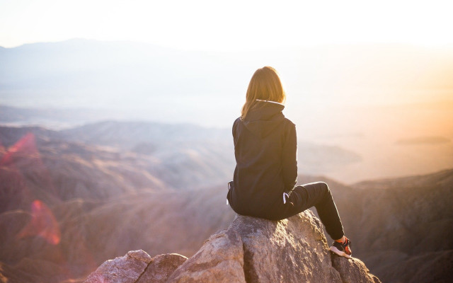 Woman sitting valley mountains sunset free wallpaper for desktop - medium preview image