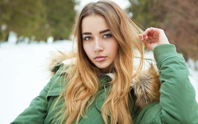 Woman green jacket snow portrait free wallpaper for desktop - medium preview image