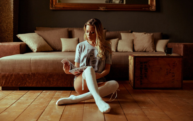 Woman sitting crossed remote couch free wallpaper for desktop - medium preview image