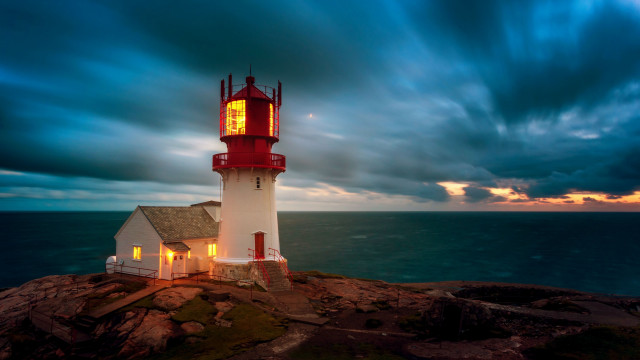 Lighthouse rocky outcropping cloudy sky free wallpaper for desktop - medium preview image
