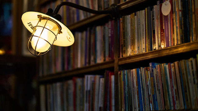 Lit lamp library bookshelf blurry free wallpaper for desktop - medium preview image
