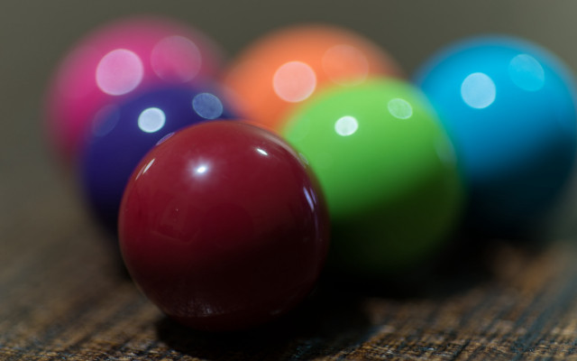 Colorful balls on wooden table free wallpaper for desktop - medium preview image