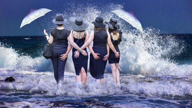 Stormy ocean girls umbrellas waves free wallpaper for desktop - medium preview image