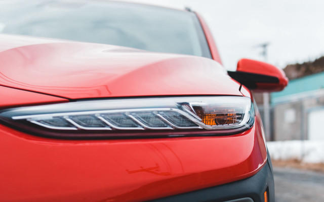 Red car snowy road building free wallpaper for desktop - medium preview image