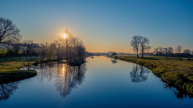 River sunset trees grassy field free wallpaper for desktop - medium preview image