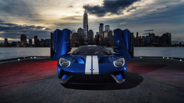 Blue sports car city skyline free wallpaper for desktop - medium preview image
