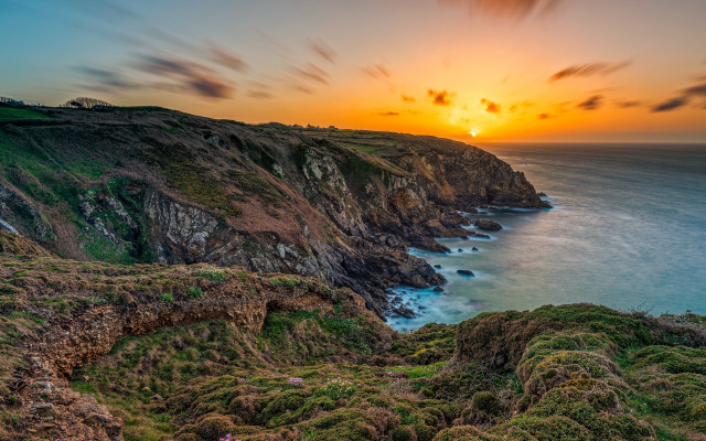 Sunset cliff lake grassy cloudy free wallpaper for desktop - medium preview image