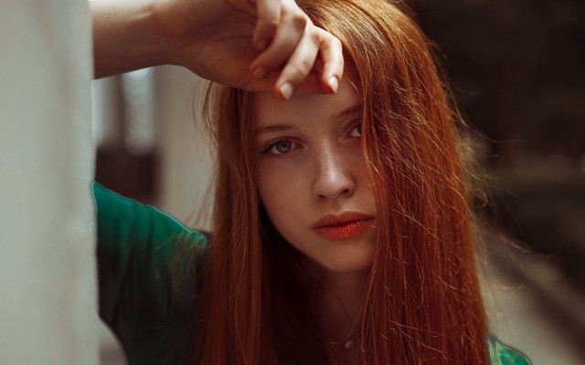 Woman redhair leaning wall serious free wallpaper for desktop - medium preview image