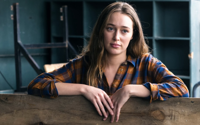 Serious woman fence plaid portrait free wallpaper for desktop - medium preview image