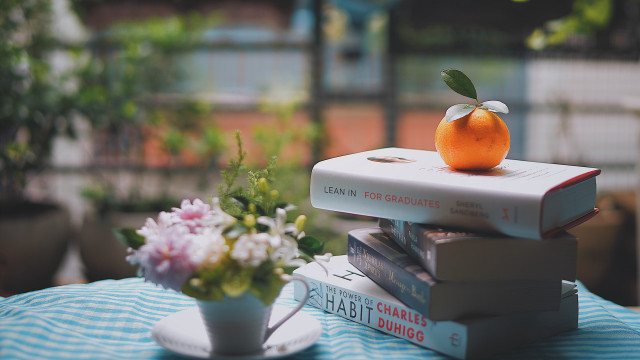 Stack books orange vase flowers #2 free wallpaper for desktop - medium preview image