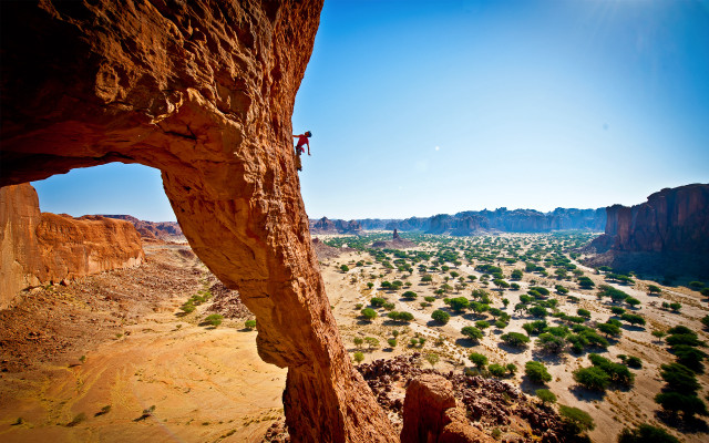 Man climbing cliff desert valley free wallpaper for desktop - medium preview image