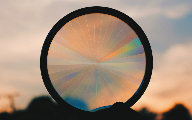 Person holding circular object blurry free wallpaper for desktop - medium preview image