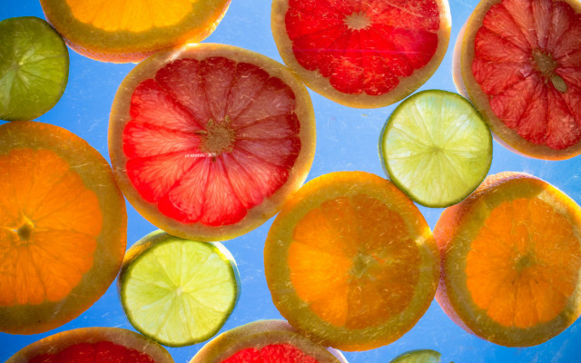 Citrus fruit slices blue surface free wallpaper for desktop - medium preview image