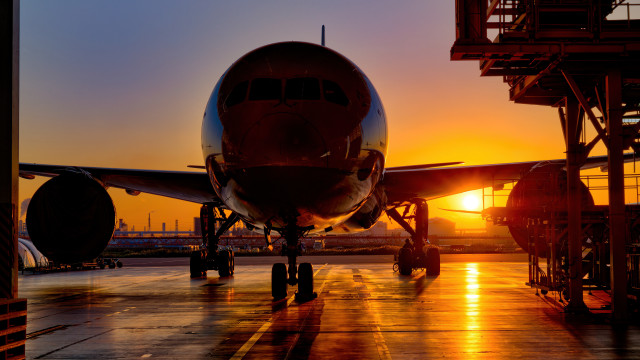 Large jetliner sunset tarmac backlit free wallpaper for desktop - medium preview image