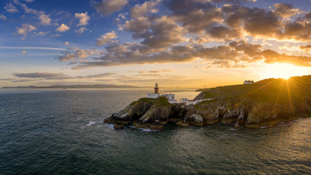Lighthouse island ocean sunset cloudy free wallpaper for desktop - medium preview image