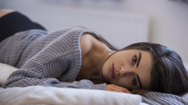 Woman bed gray sweater black free wallpaper for desktop - medium preview image